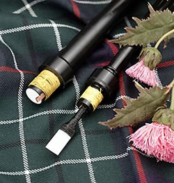 image of bagpipe chanter, tartan and thistle